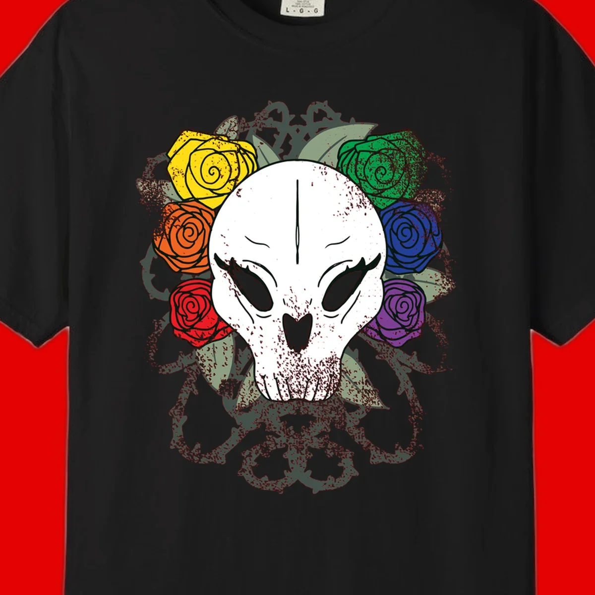 White skull with rainbow colored roses in yellow, orange, red, blue, green, and purple surrounding it on gray background