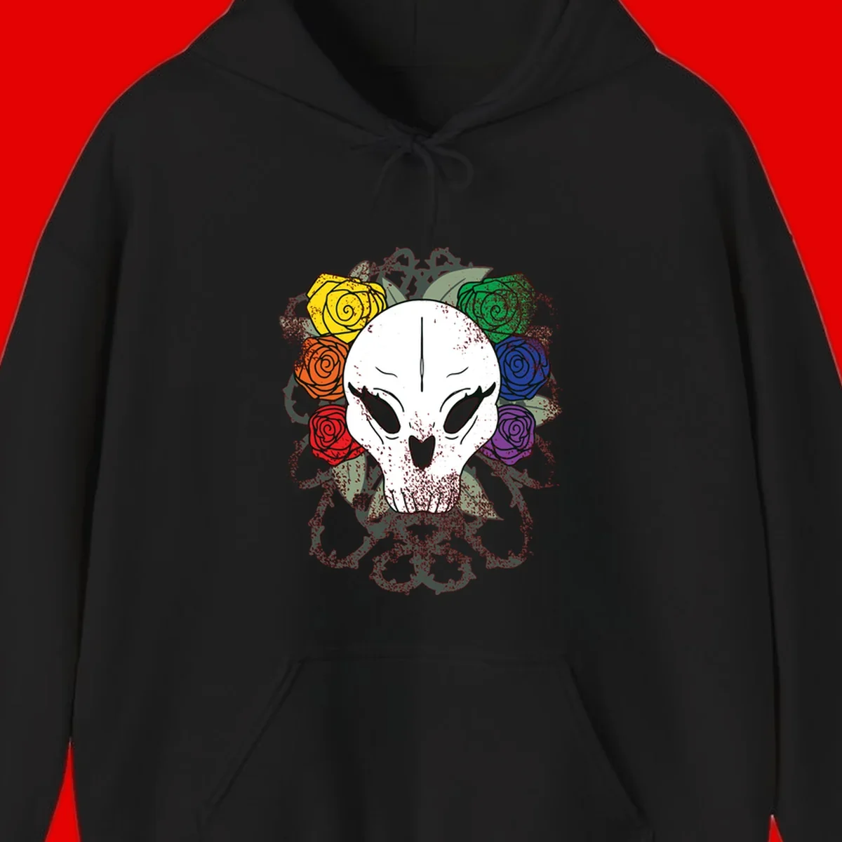 White skull with rainbow colored roses in yellow, orange, red, blue, green, and purple surrounding it on gray background