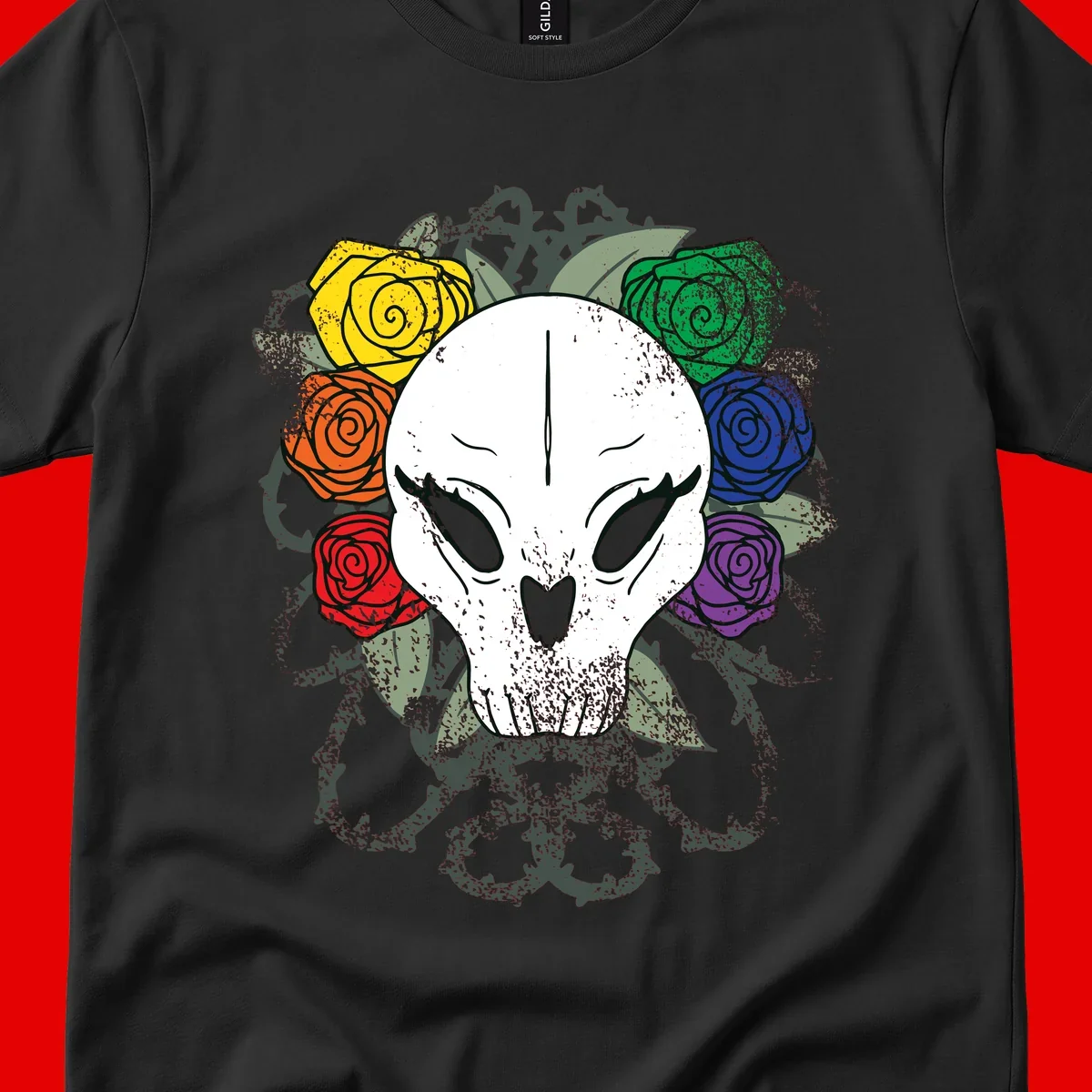 White skull with rainbow colored roses in yellow, orange, red, blue, green, and purple surrounding it on gray background