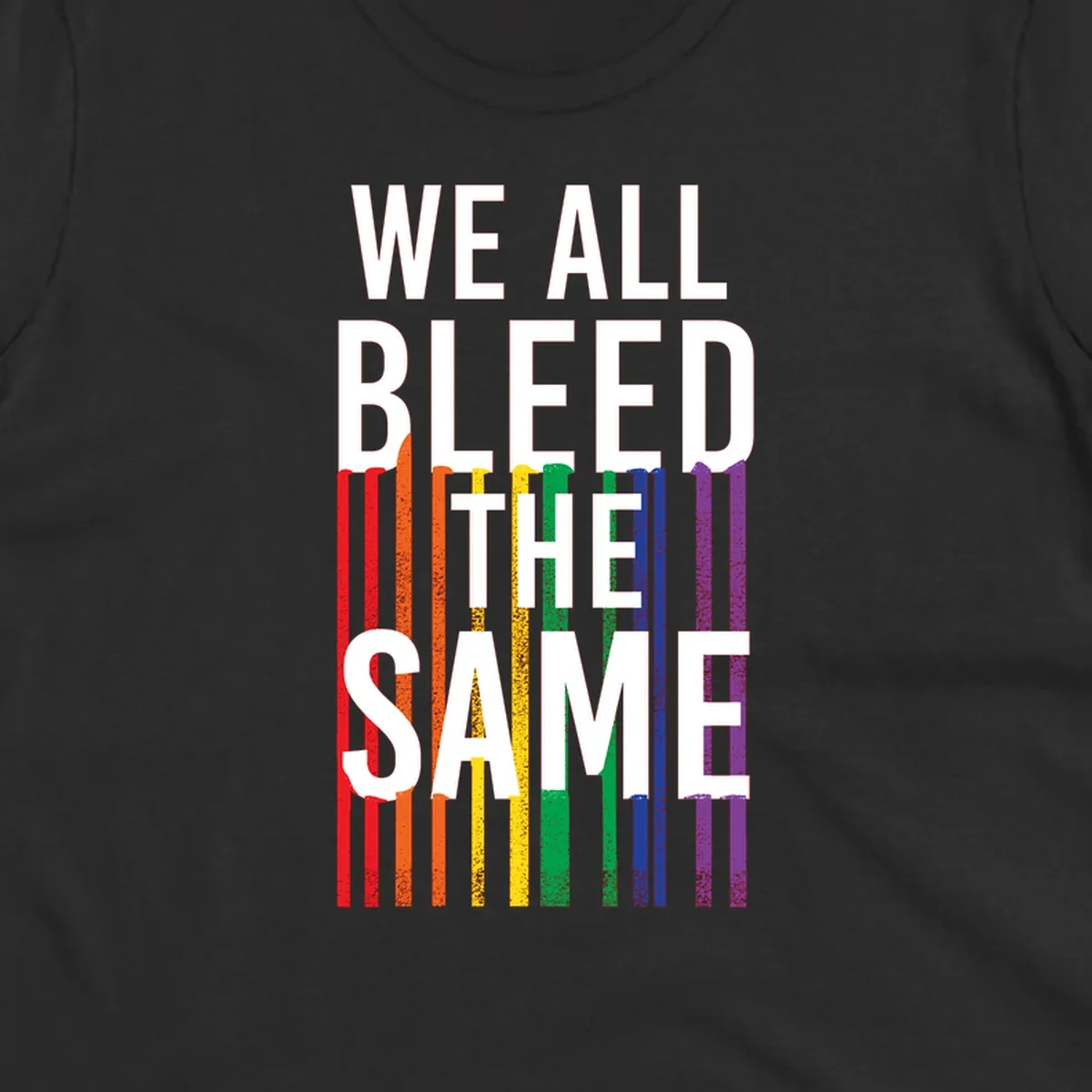 White bold text 'We All Bleed The Same' over rainbow vertical stripes in pride flag colors on gray background