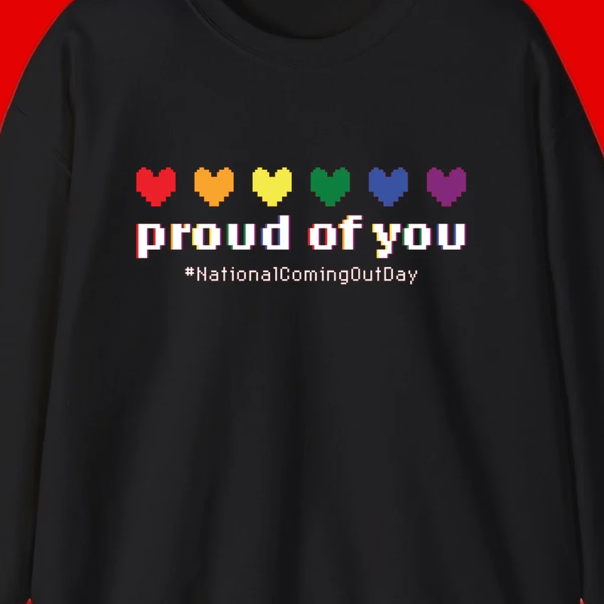 Pixel-art design with six rainbow hearts and text reading 'proud of you #NationalComingOutDay' celebrating coming out visibility
