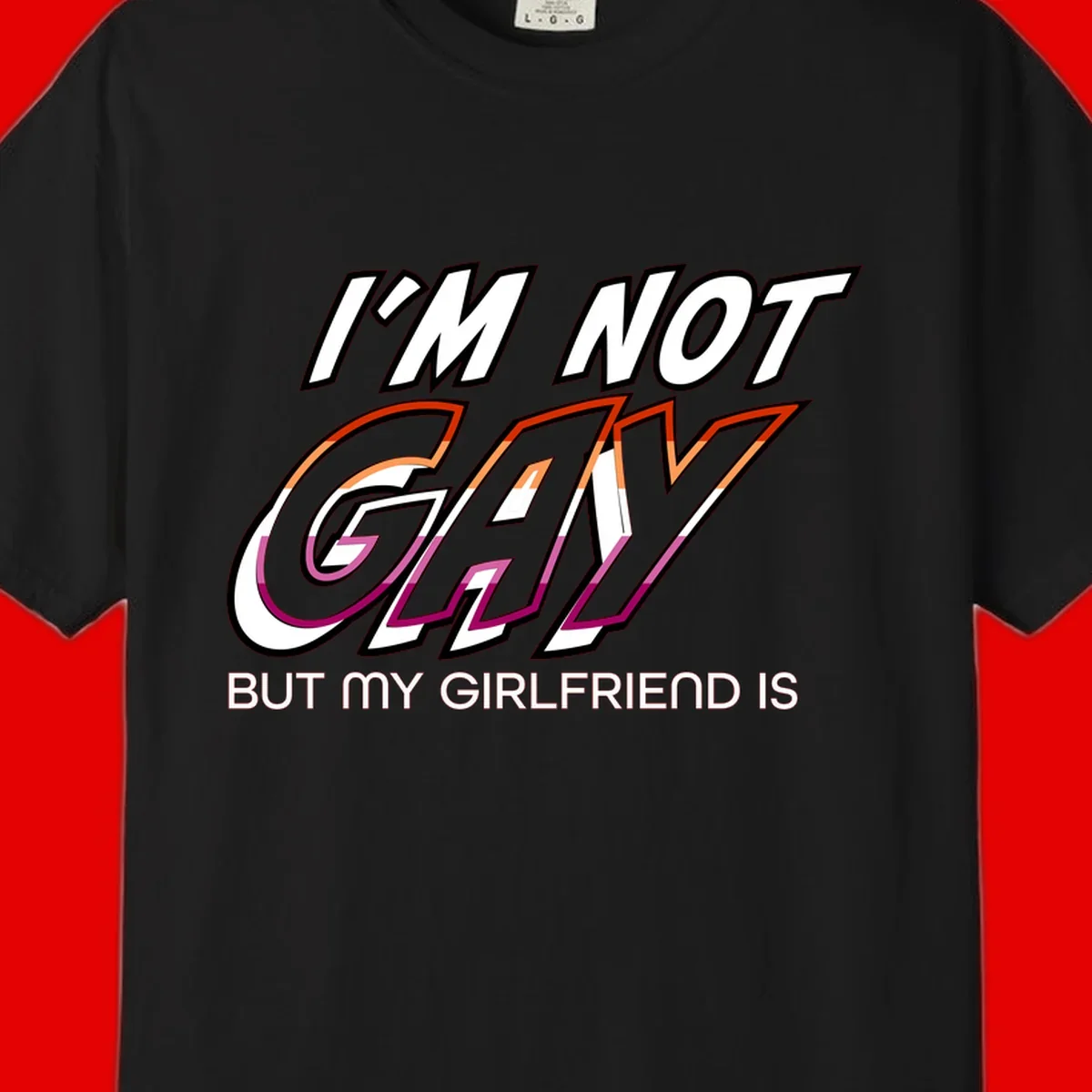 Bold typography design reading 'I'm not gay but my girlfriend is' in orange and magenta layered 3D letters