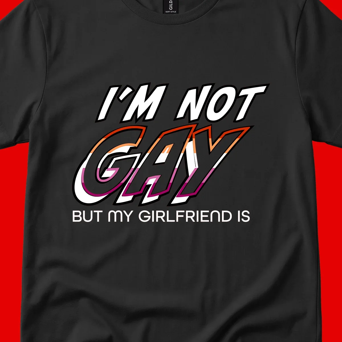 Bold typography design reading 'I'm not gay but my girlfriend is' in orange and magenta layered 3D letters