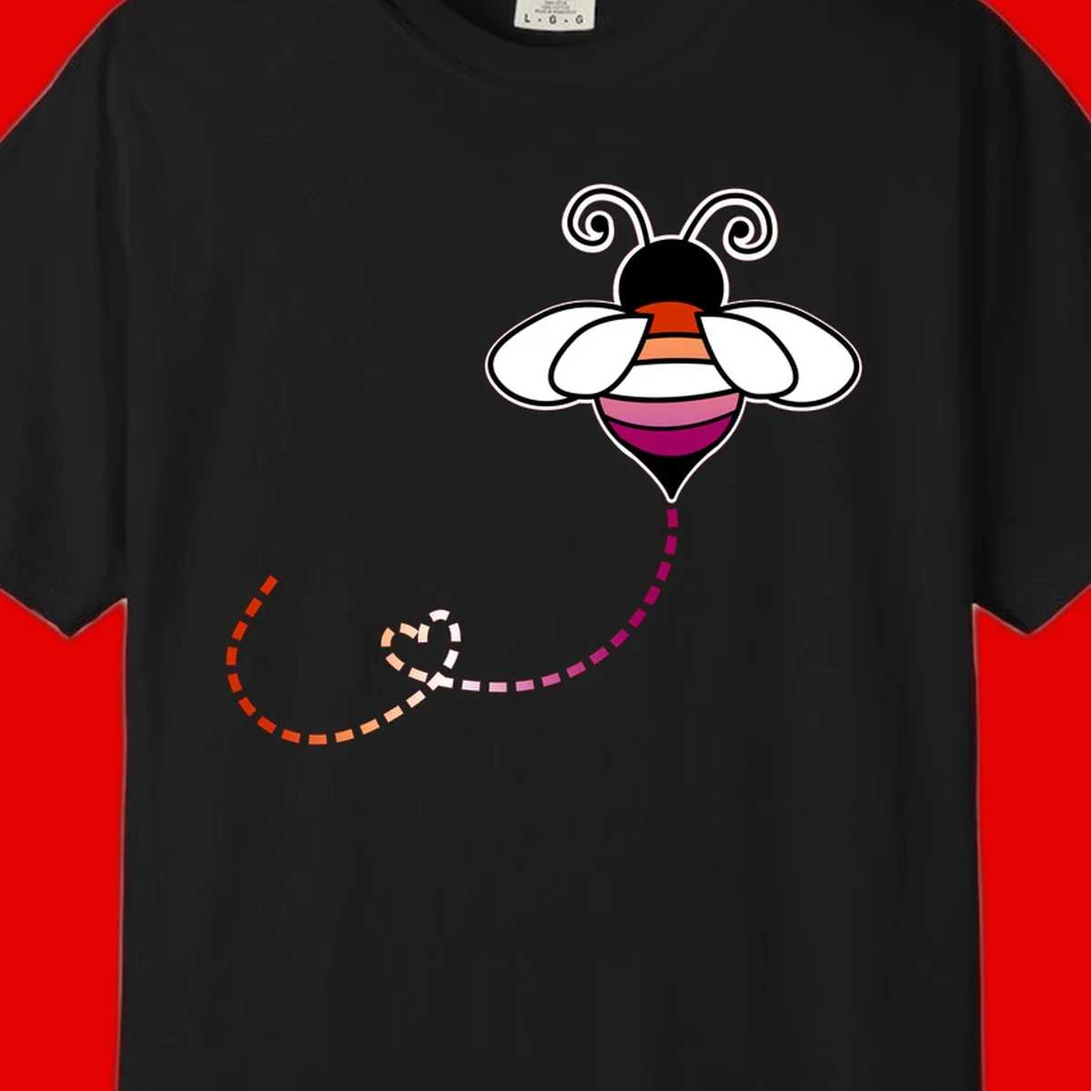 Illustrated rainbow pride bee with spiral antennae, white wings, and colorful striped body with dotted flight path
