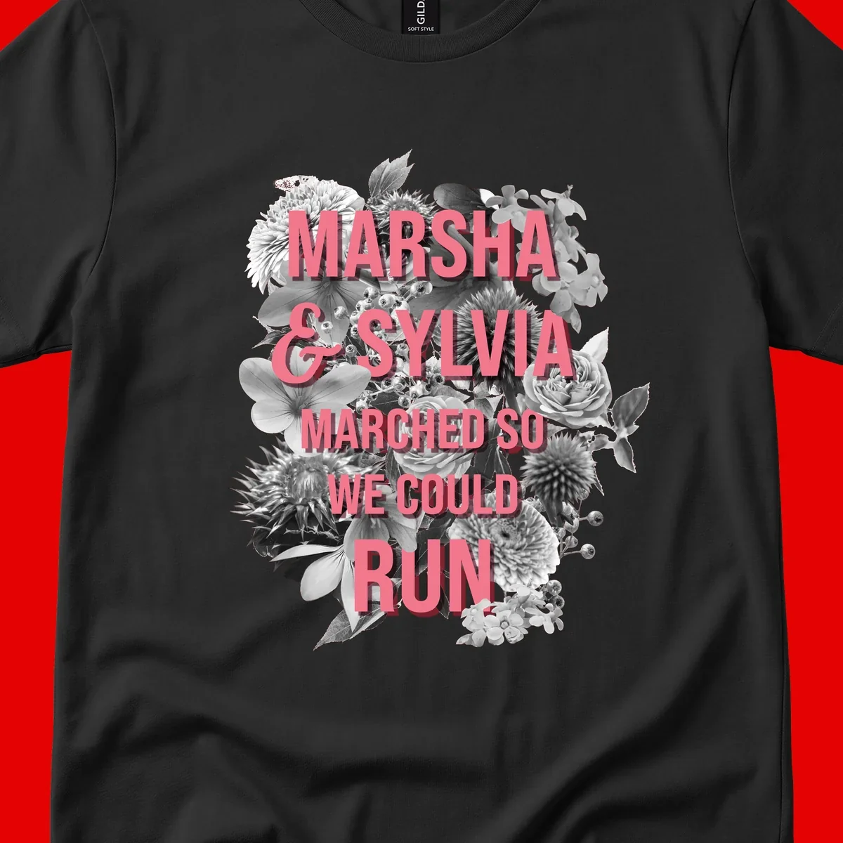 Pink text reading 'Marsha & Sylvia Marched So We Could Run' overlaid on black and white floral arrangement with roses and dahlias