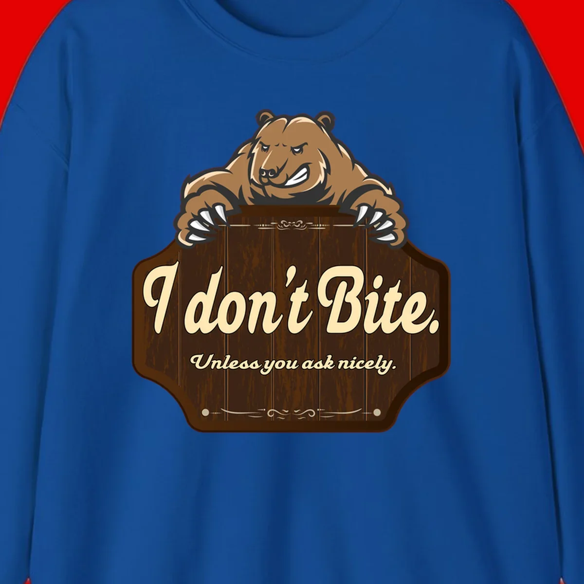 Brown grizzly bear grinning mischievously while holding a wooden sign reading 'I don't Bite. Unless you ask nicely' with decorative vintage styling