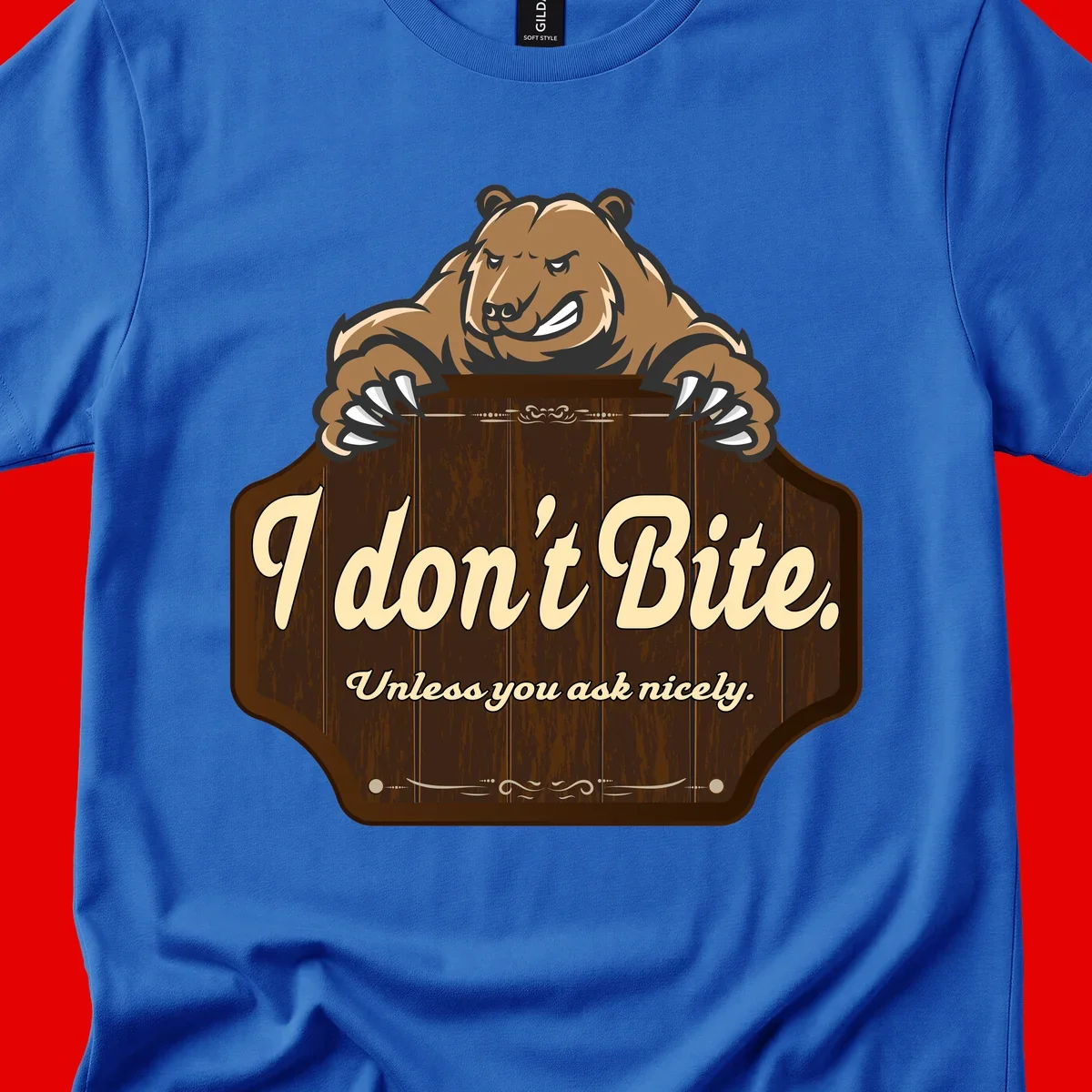 Brown grizzly bear grinning mischievously while holding a wooden sign reading 'I don't Bite. Unless you ask nicely' with decorative vintage styling