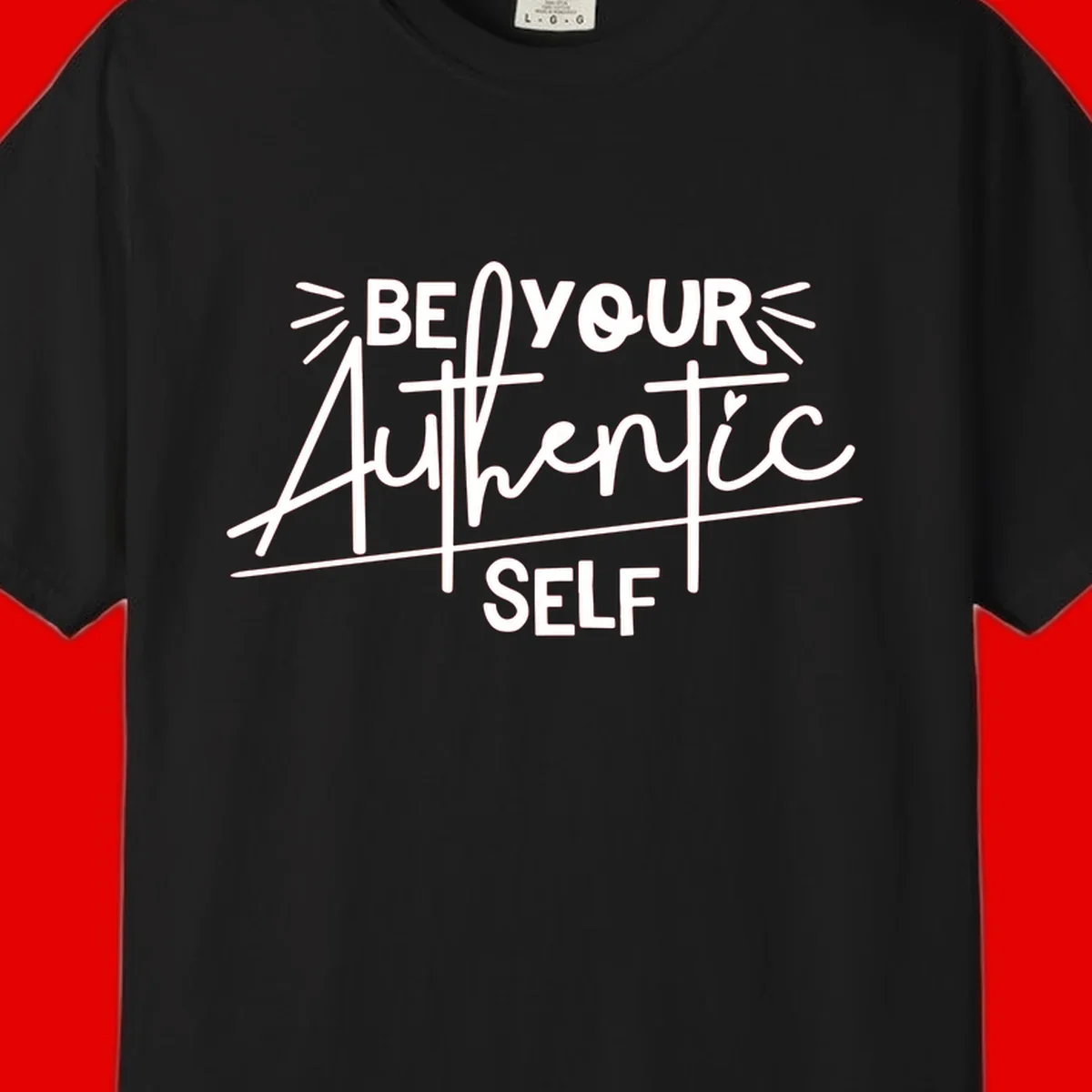 White hand-lettered text reading 'Be Your Authentic Self' with decorative radiating lines and a small heart on gray background