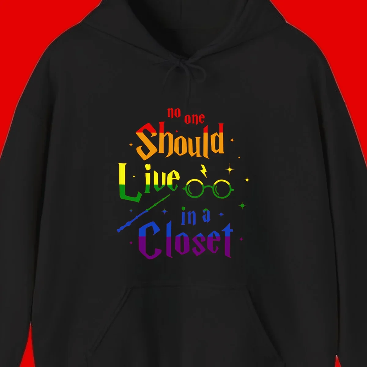 Rainbow gradient text reading 'no one Should live in a Closet' with magical elements including glasses, wand, and stars on gray background