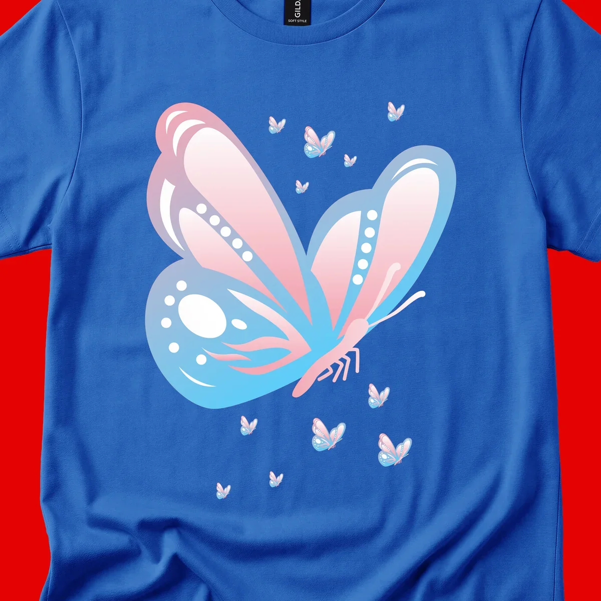 Large butterfly with pink and blue gradient wings featuring white dot details, surrounded by smaller flying butterflies on gray background
