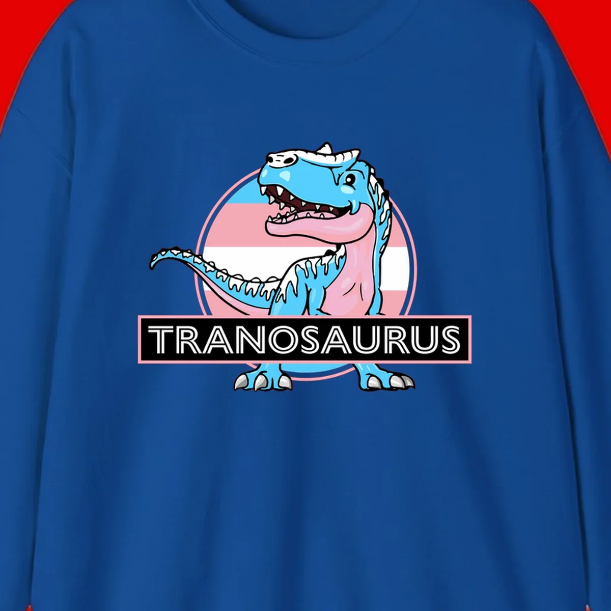 Blue cartoon T-Rex dinosaur with open mouth against pink and white pride flag circular background, labeled Tranosaurus