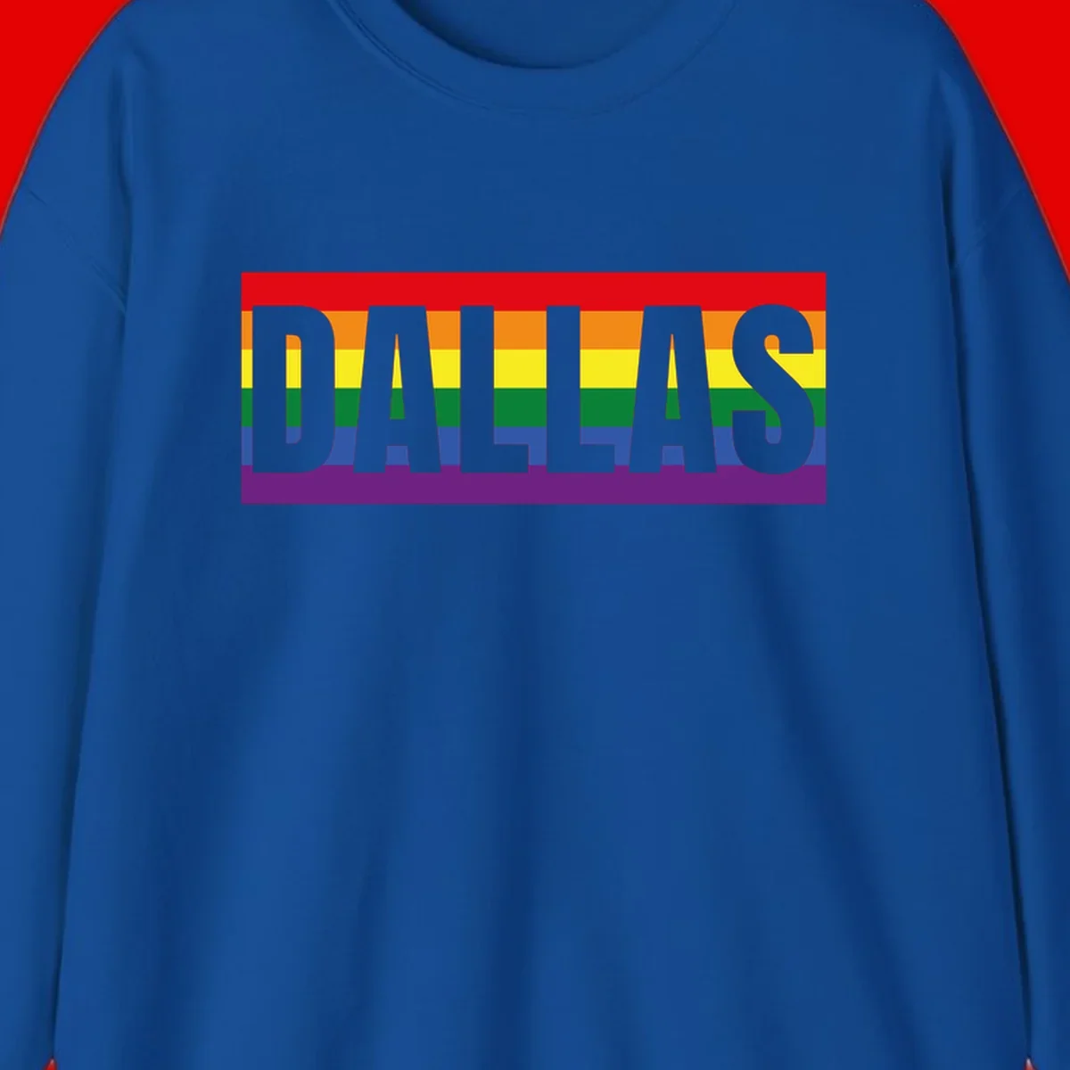 Gray DALLAS text overlaid on rainbow pride flag with red, orange, yellow, green, blue, and purple horizontal stripes