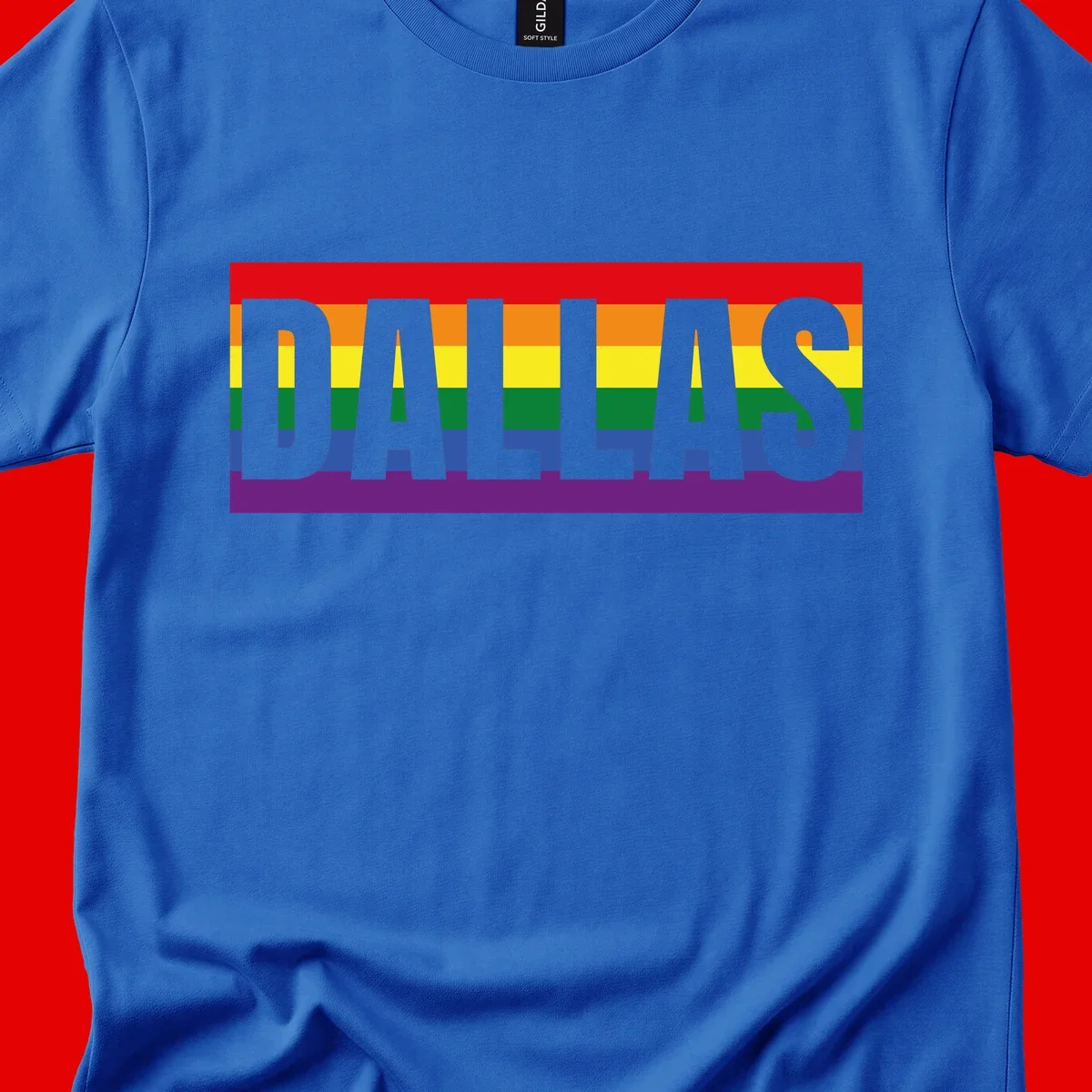 Gray DALLAS text overlaid on rainbow pride flag with red, orange, yellow, green, blue, and purple horizontal stripes