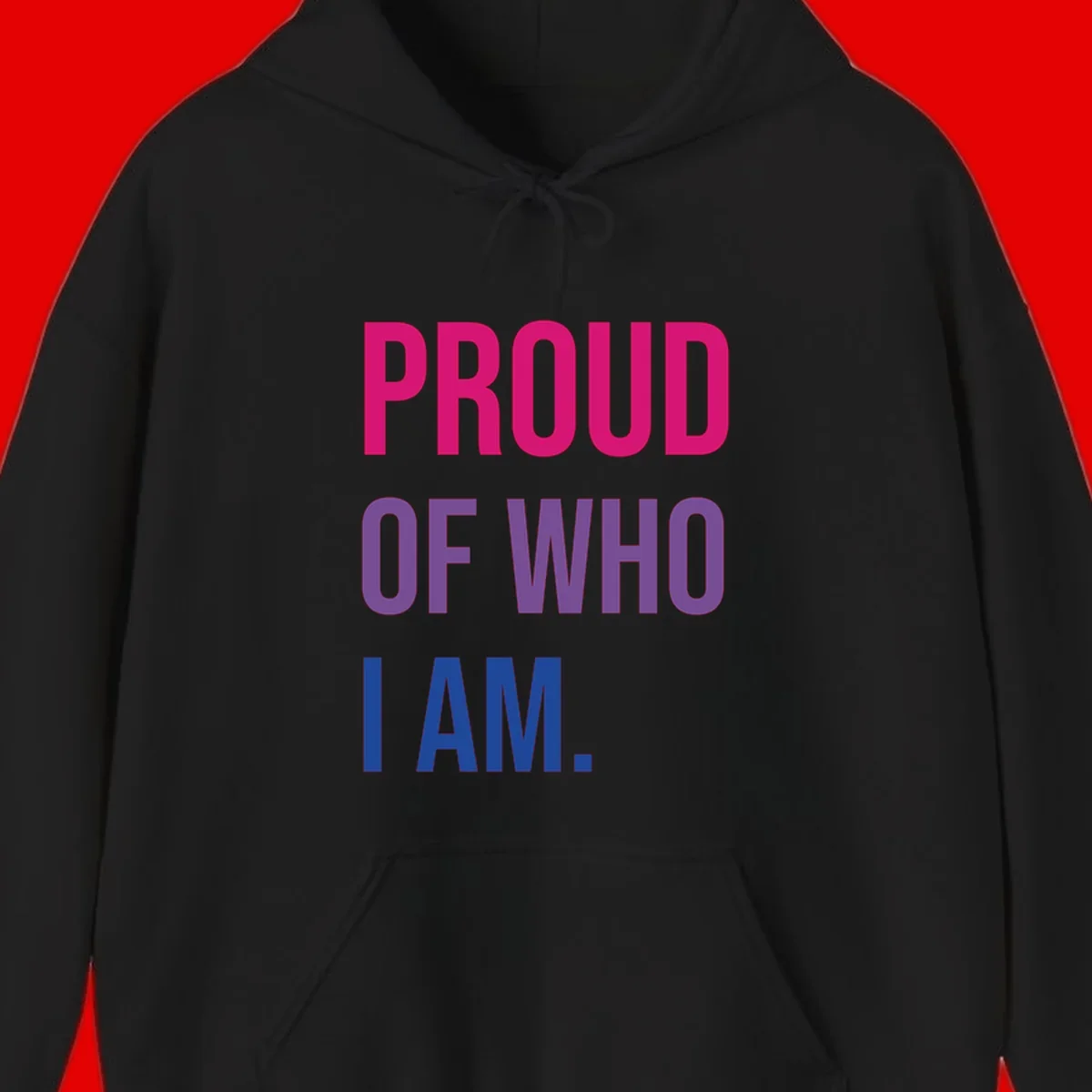 Bold colorful typography design reading 'PROUD OF WHO I AM' in magenta, purple, and blue letters on gray background