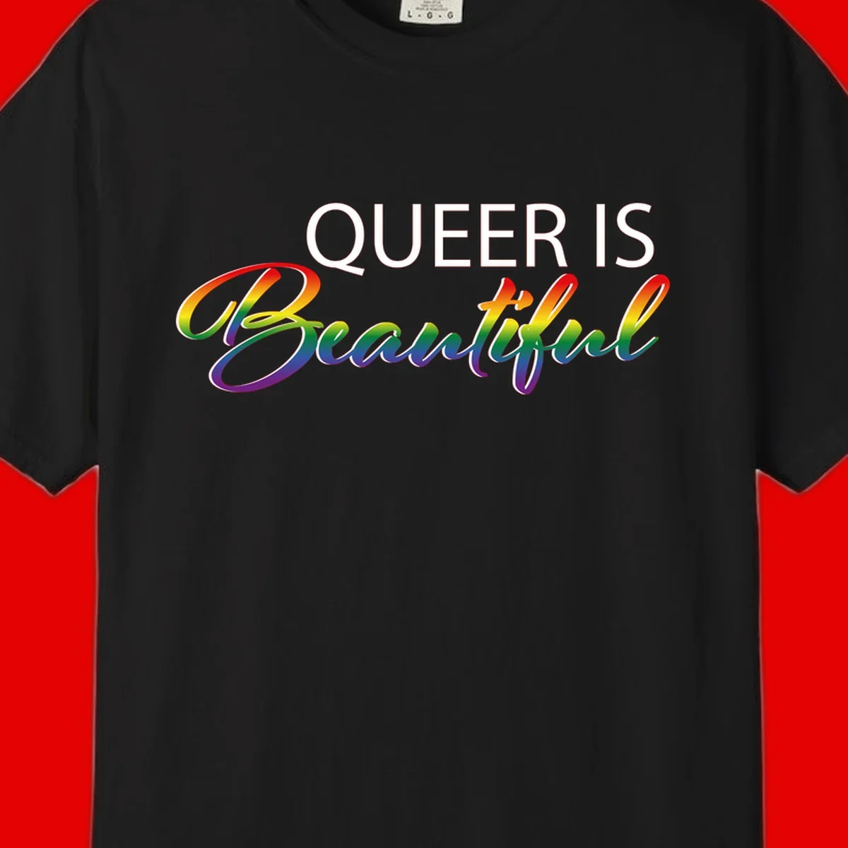 Rainbow gradient text reading 'Queer Is Beautiful' in pride flag colors on gray background