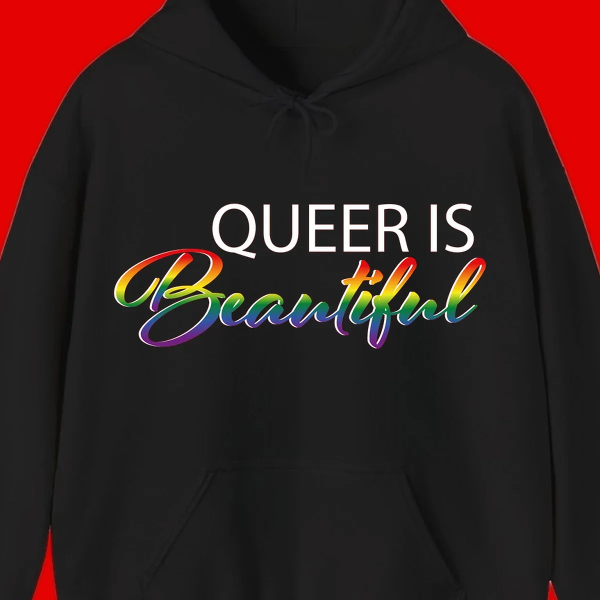 Rainbow gradient text reading 'Queer Is Beautiful' in pride flag colors on gray background