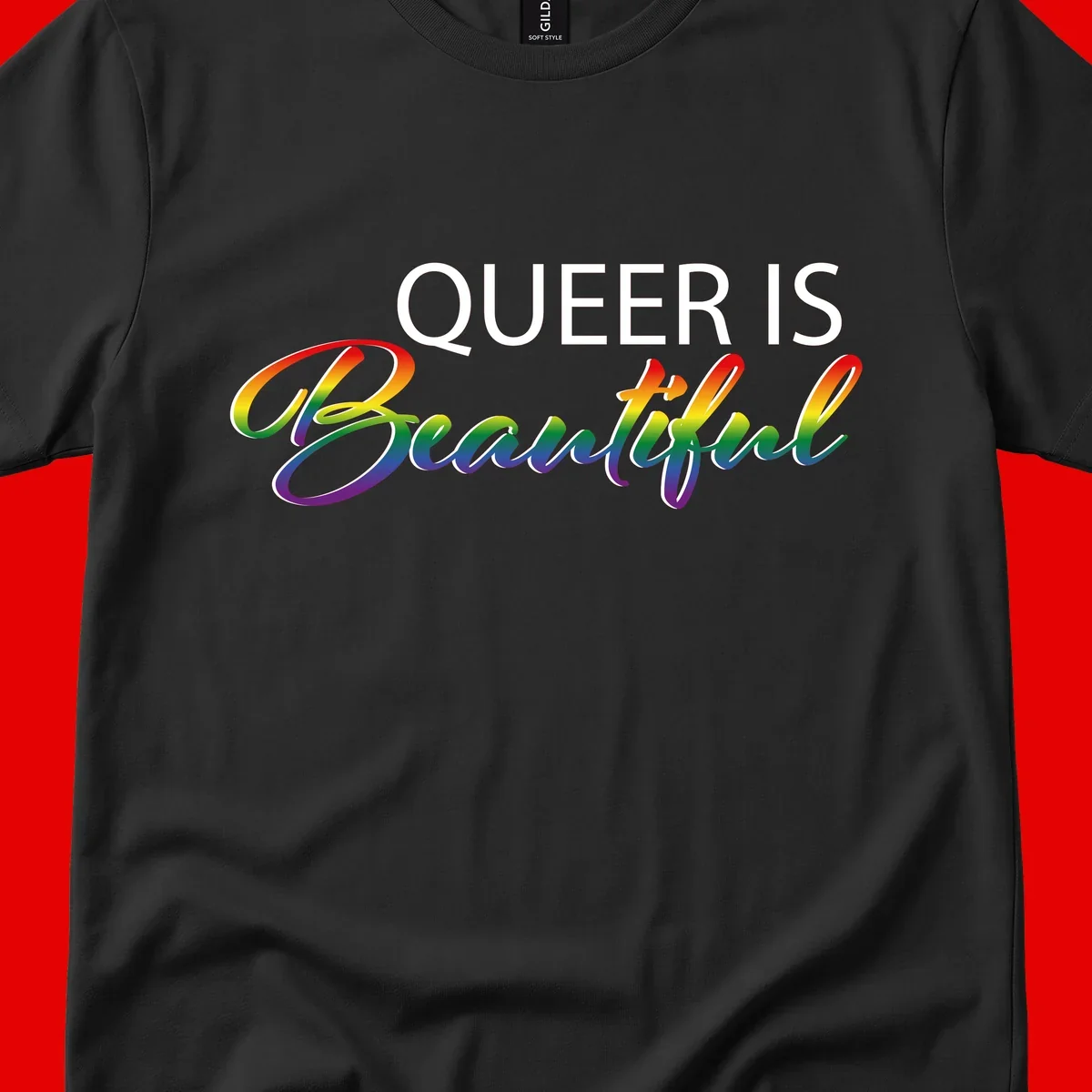 Rainbow gradient text reading 'Queer Is Beautiful' in pride flag colors on gray background
