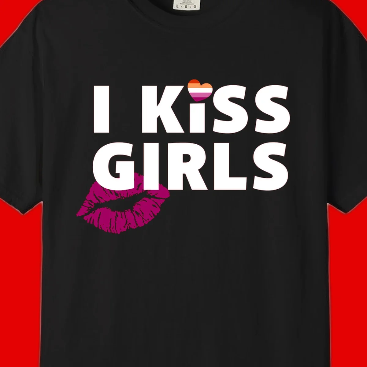 I Kiss Girls pride design with magenta lip print, rainbow heart, and bold white lettering celebrating lesbian identity