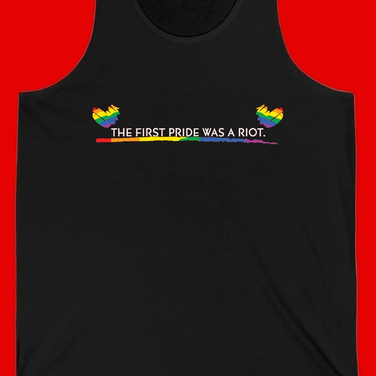 Gray background with white text reading 'THE FIRST PRIDE WAS A RIOT' surrounded by rainbow pride hearts and gradient stripe