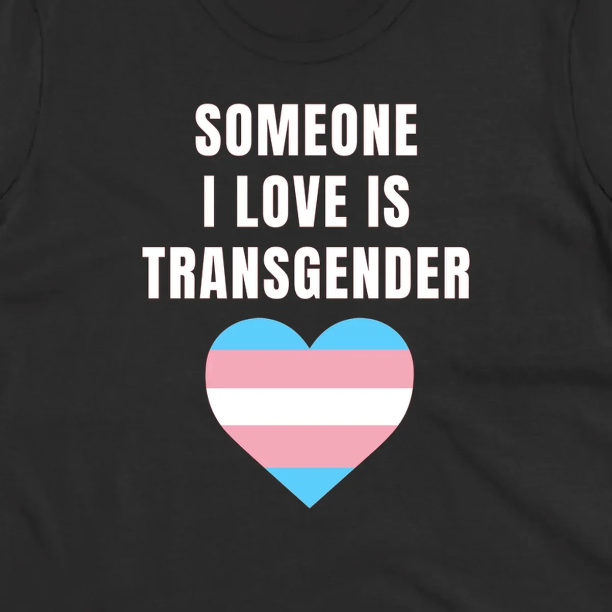 Gray background with white text reading 'Someone I Love Is Transgender' above a heart featuring blue, pink, and white transgender flag stripes