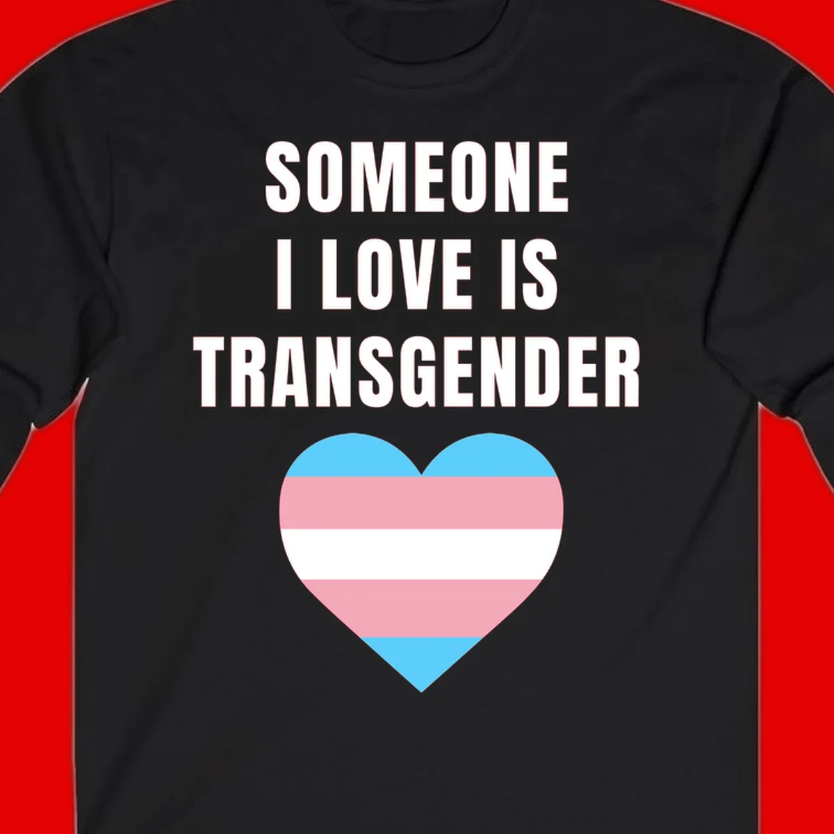 Gray background with white text reading 'Someone I Love Is Transgender' above a heart featuring blue, pink, and white transgender flag stripes