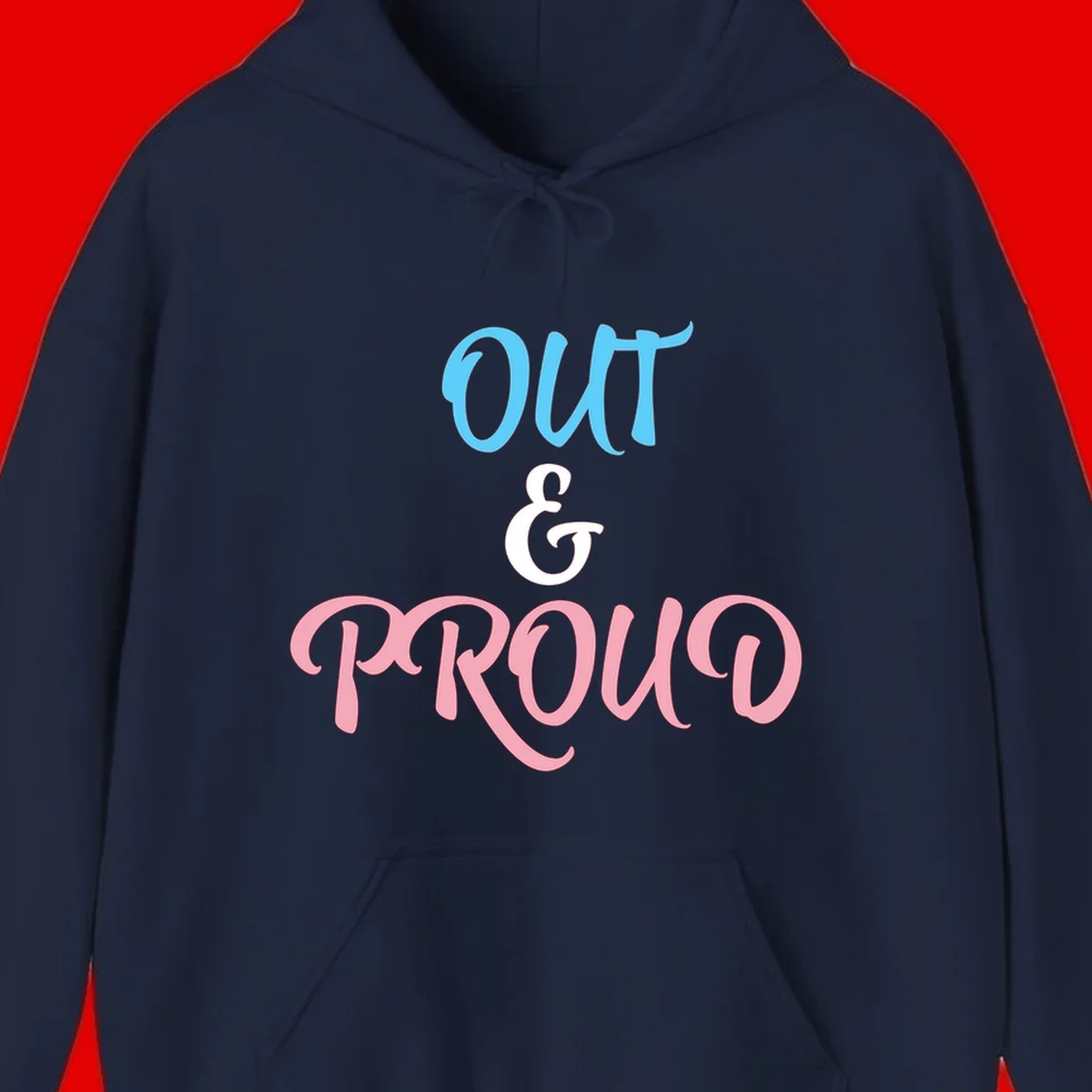 Out and proud pride design with blue 'OUT' text, white ampersand, and pink 'PROUD' lettering on gray background
