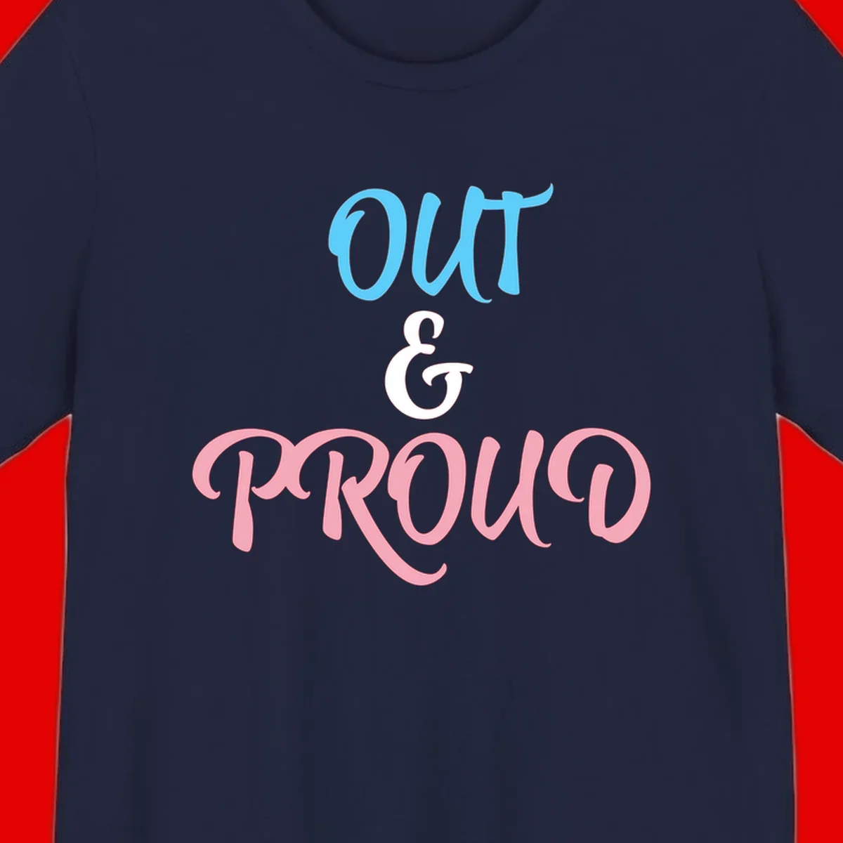 Out and proud pride design with blue 'OUT' text, white ampersand, and pink 'PROUD' lettering on gray background