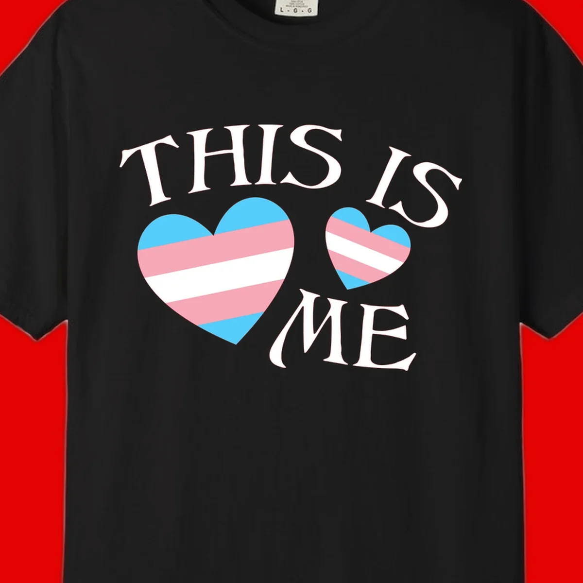 Two striped hearts in trans flag colors (blue, pink, white) with 'THIS IS ME' text celebrating trans pride and identity