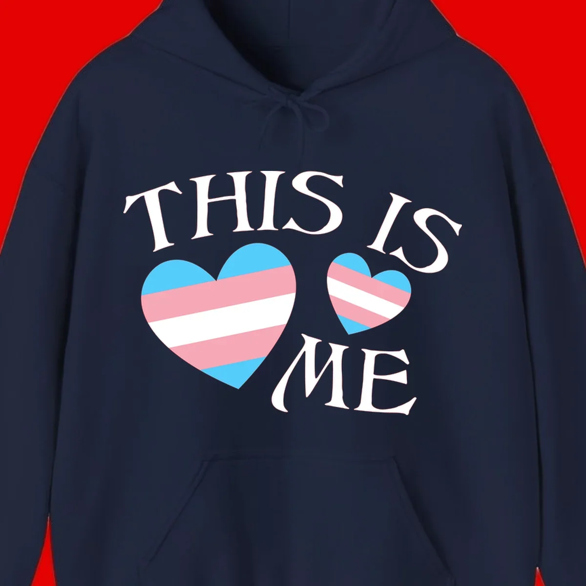 Two striped hearts in trans flag colors (blue, pink, white) with 'THIS IS ME' text celebrating trans pride and identity