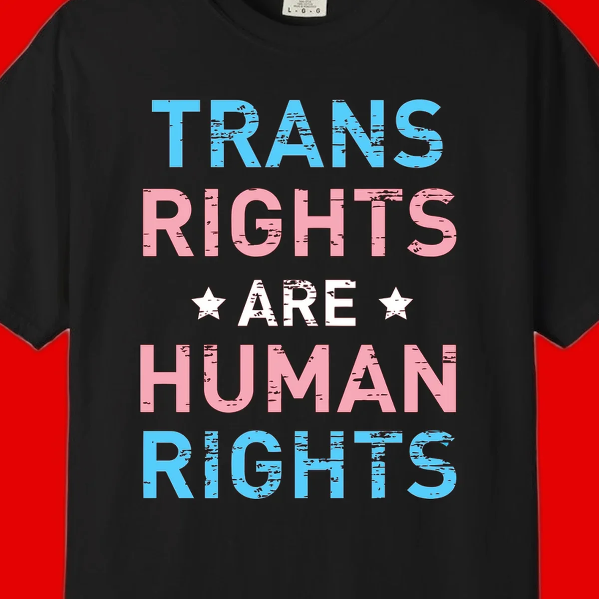 Distressed typography design reading 'TRANS RIGHTS ARE HUMAN RIGHTS' in cyan, pink, and white text with decorative stars on gray background