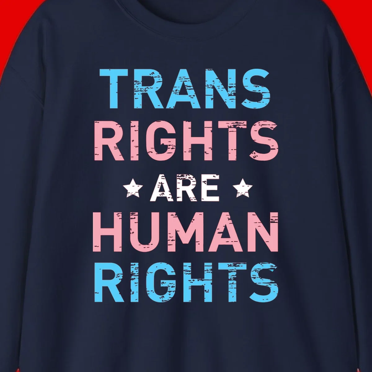 Distressed typography design reading 'TRANS RIGHTS ARE HUMAN RIGHTS' in cyan, pink, and white text with decorative stars on gray background