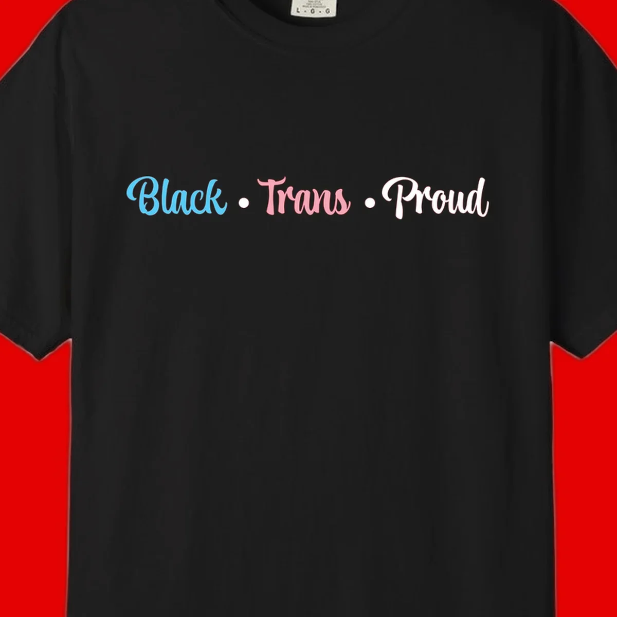Black Trans Proud design with blue, pink, and white text on gray background, featuring decorative dots