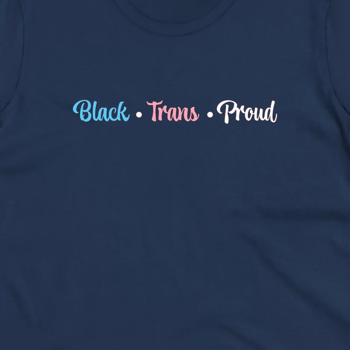 Black Trans Proud design with blue, pink, and white text on gray background, featuring decorative dots