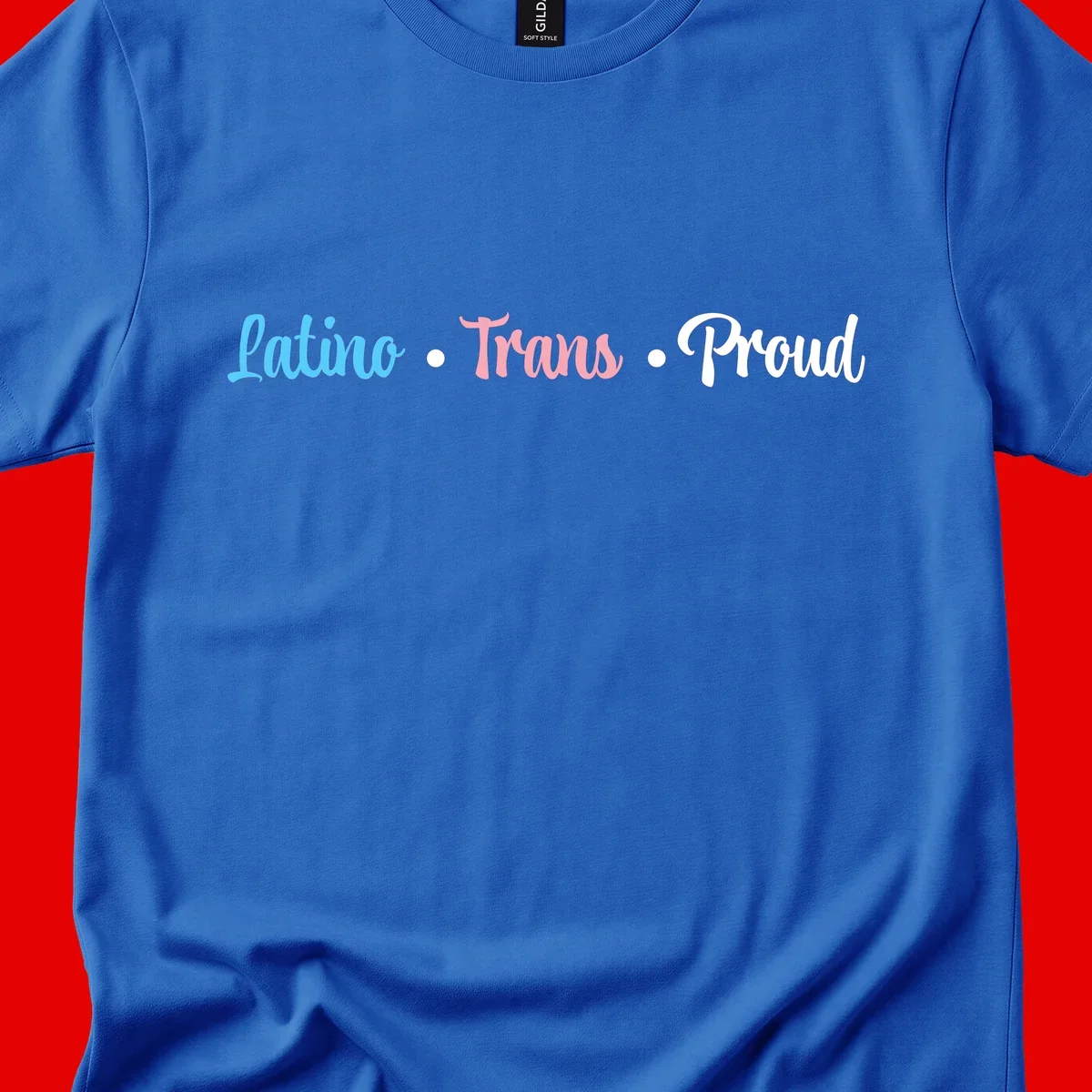 Latino Trans Proud design with blue, pink, and white script text on gray background celebrating LGBTQ identity