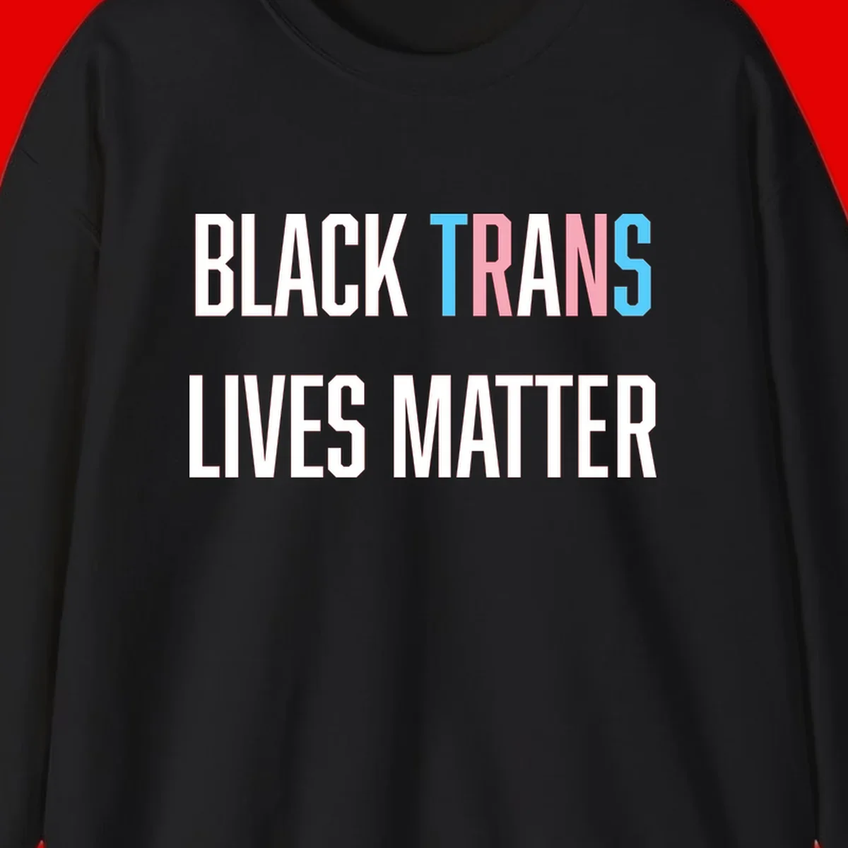 Bold typography design reading 'BLACK TRANS LIVES MATTER' with 'TRANS' in pink and cyan pride colors on gray background