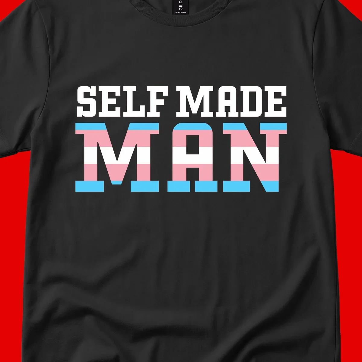 Bold 'Self Made' text filled with transgender pride flag stripes in blue, pink, and white on gray background