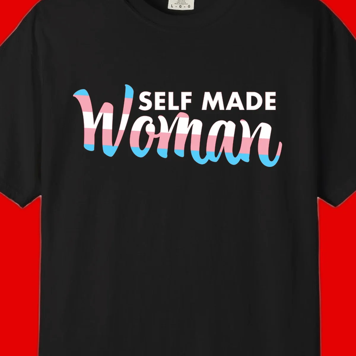 Self Made Woman design featuring bold wavy striped lettering in pink, white, and blue trans flag colors