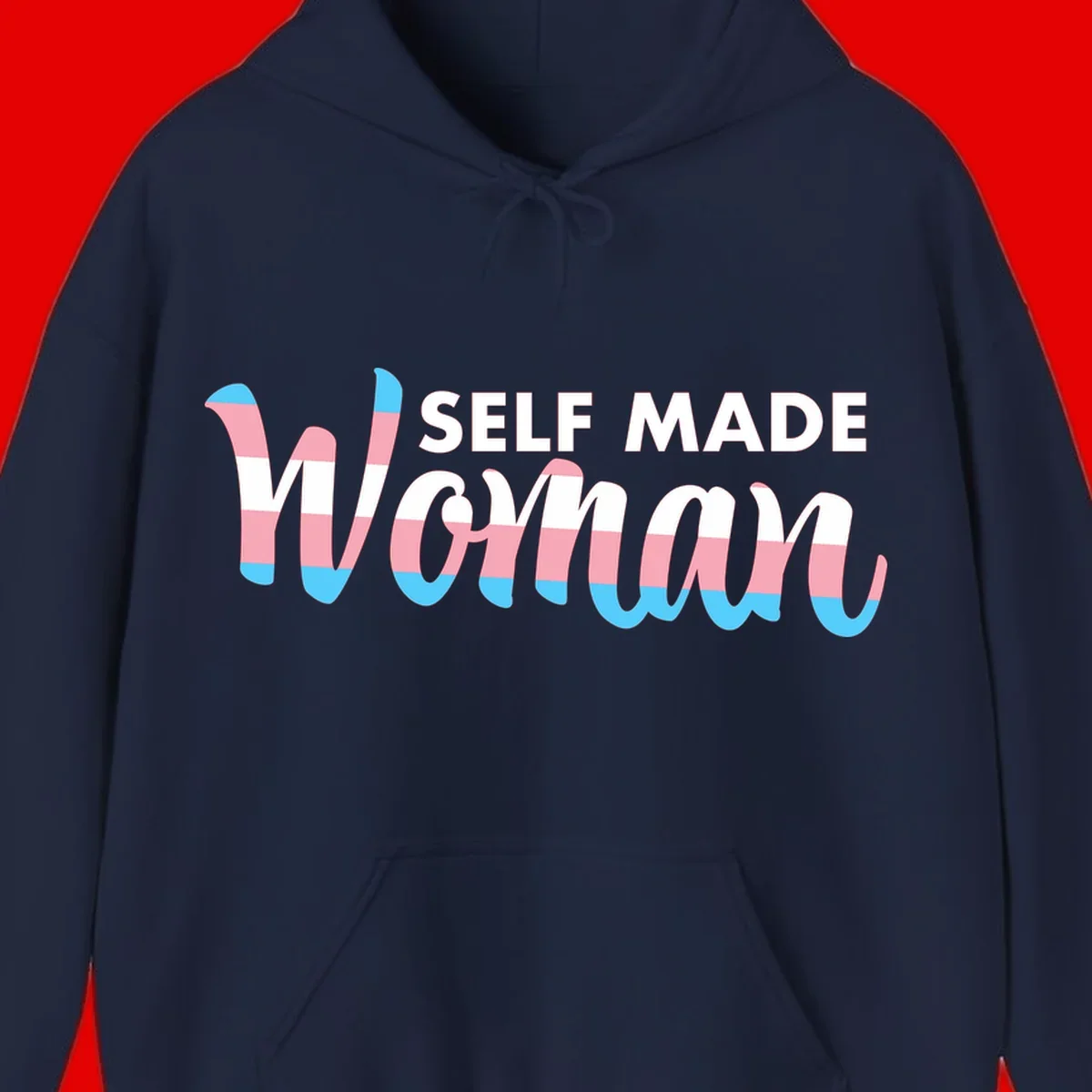 Self Made Woman design featuring bold wavy striped lettering in pink, white, and blue trans flag colors