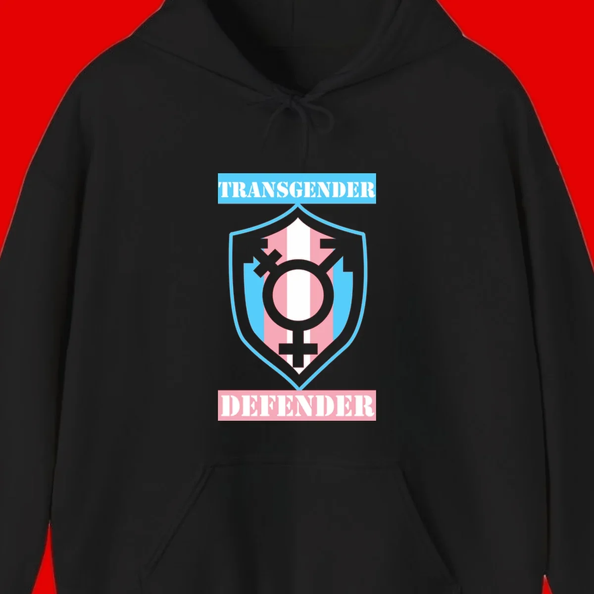 Transgender defender shield badge with centered symbol, protective arrows, and cyan-pink color scheme