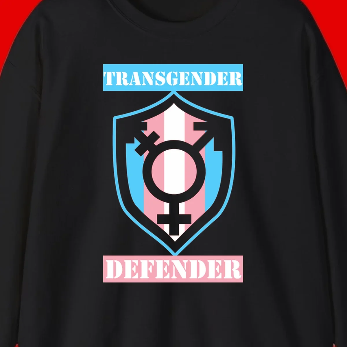 Transgender defender shield badge with centered symbol, protective arrows, and cyan-pink color scheme