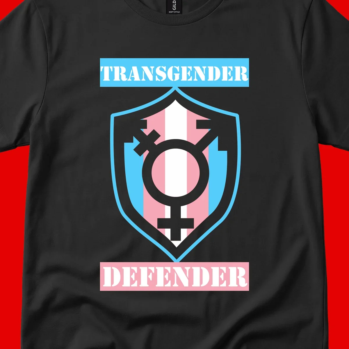 Transgender defender shield badge with centered symbol, protective arrows, and cyan-pink color scheme