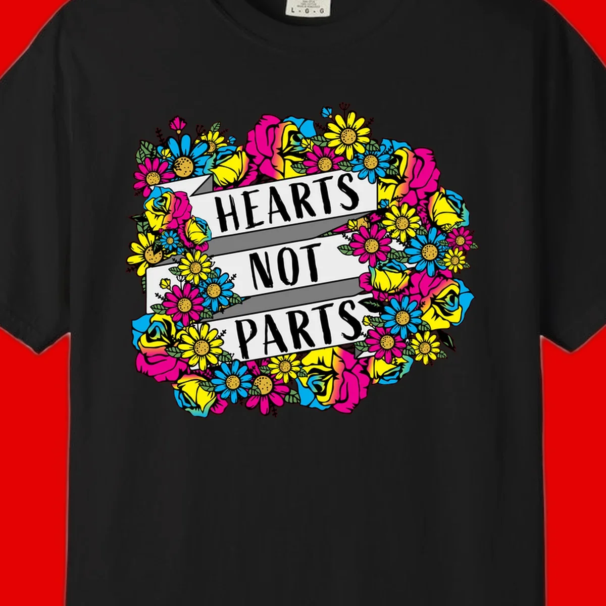 Hearts Not Parts pride design with colorful floral wreath featuring yellow daisies, magenta roses, and blue flowers surrounding bold statement text