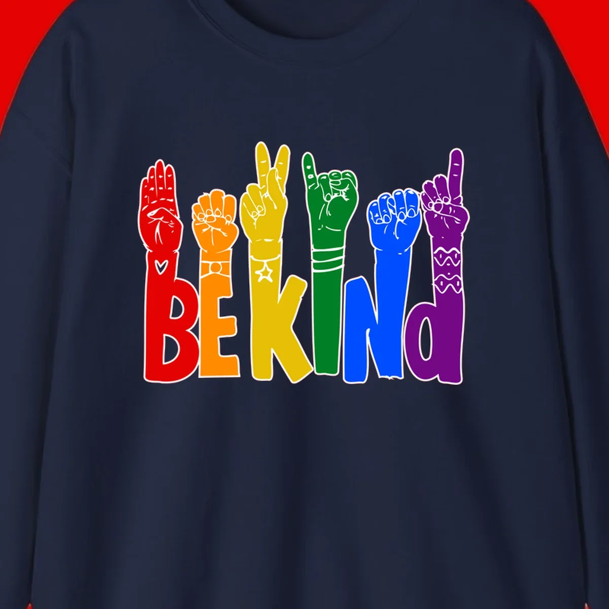 Six colorful raised fists in rainbow colors with 'BE KIND' text, promoting pride, equality, and inclusive messaging