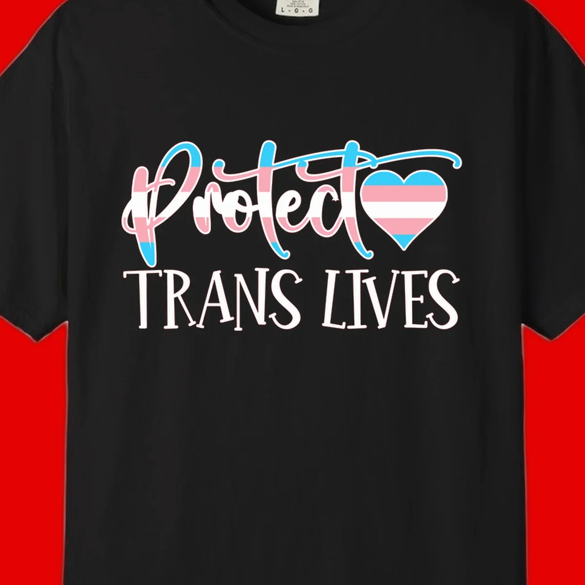 Stylized text 'I heart TRANS LIVES' with decorative letters and a trans flag-striped heart symbol in pink, white, and blue colors