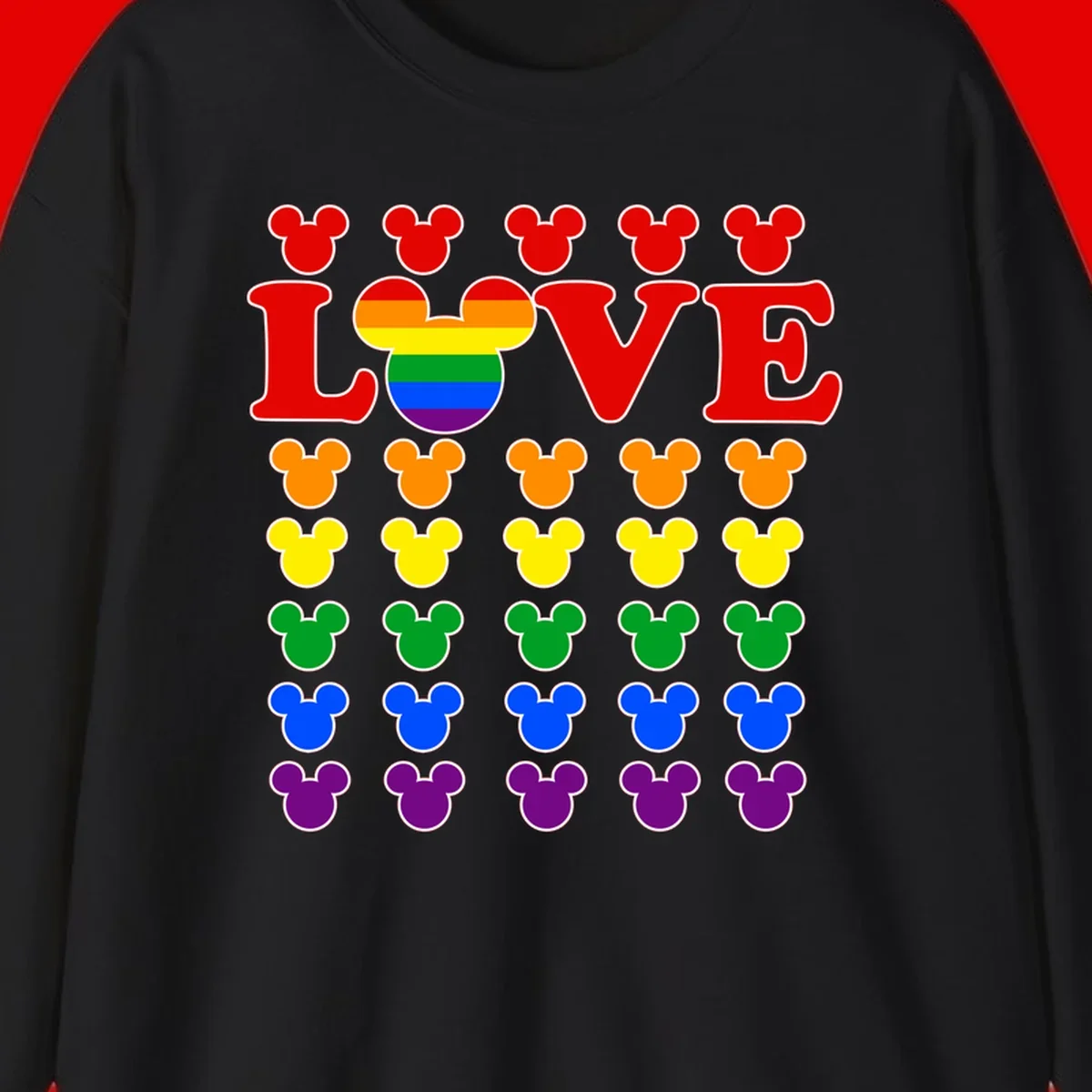 Mickey Love Pride design featuring bold red LOVE text with rainbow-striped Mickey head and colorful Mickey silhouettes border