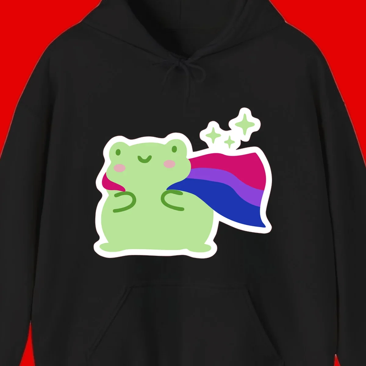 Smiling green frog wearing a flowing rainbow cape with floating sparkles, pride-frog-cape design illustration