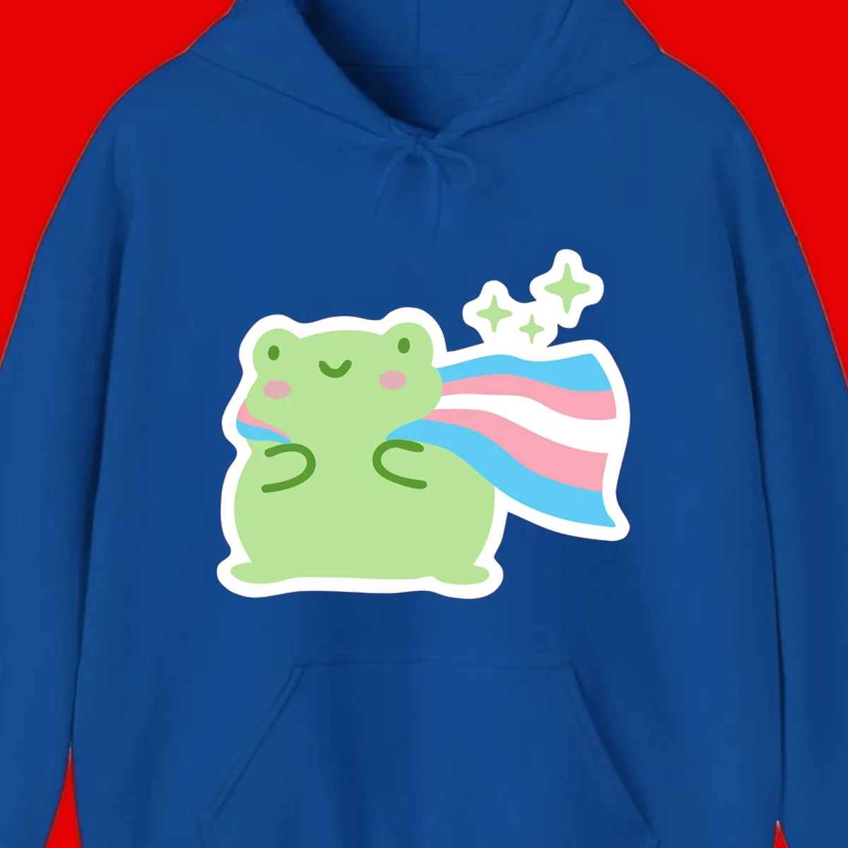 Cheerful green frog with sparkles wearing a magical pink and blue striped cape