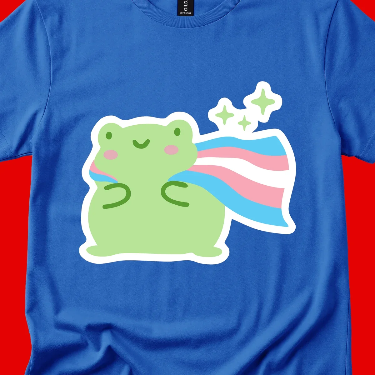 Cheerful green frog with sparkles wearing a magical pink and blue striped cape