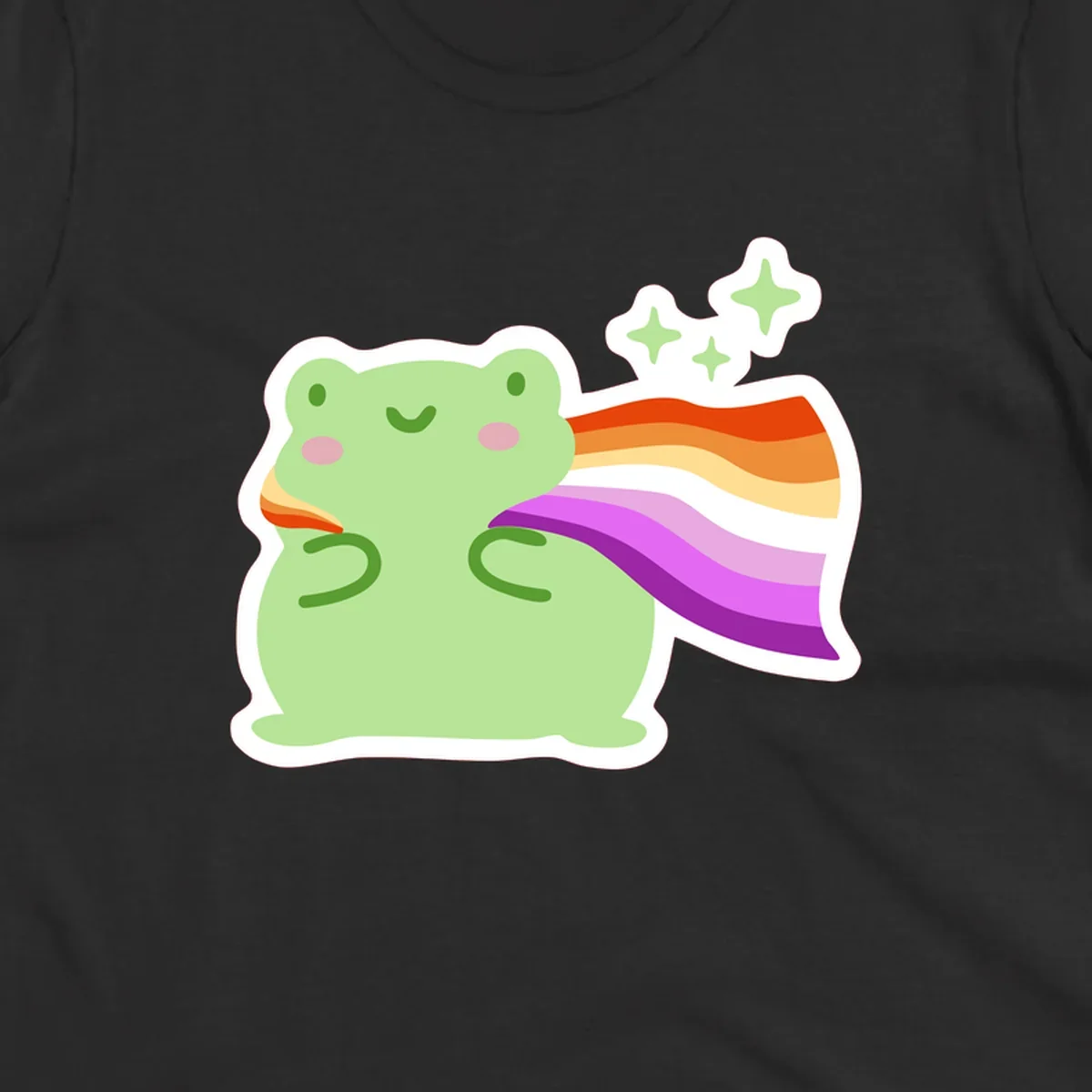 Cute green frog with pink cheeks wearing a rainbow pride cape, surrounded by sparkle stars