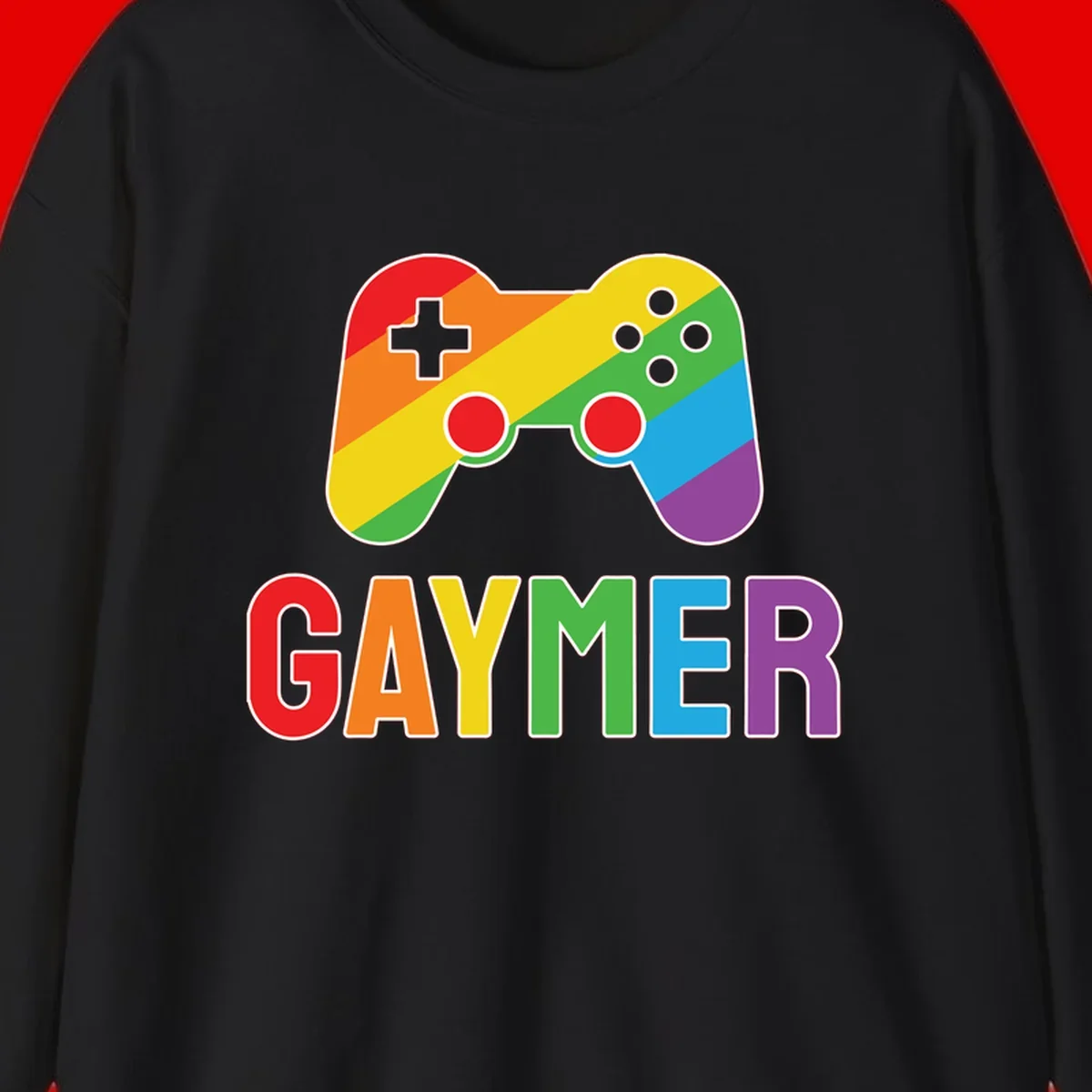 Rainbow gradient game controller with multicolored GAMER text below, featuring pride colors in diagonal stripes